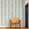 Scion On The Vine wallpaper in Cornflower and Kelly Green used in a neutral interior highlighting trailing foliage motif.