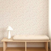 Scion Dove & Deer Lilac wallpaper styled behind a wooden bench, showcasing detailed woodland motif.