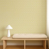 Scion Scallop Frill Buttercup wallpaper behind a wooden bench, highlighting bright yellow wave pattern.
