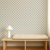Scion Ditsy Daisy Denim wallpaper used behind a wooden bench, highlighting small-scale blue daisy design.