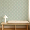 Scion Ditsy Daisy Powder Blue wallpaper styled behind a wooden bench, displaying small-scale daisy motif on blue background.
