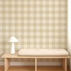Scion Central Check Pebble wallpaper styled behind a wooden bench, displaying large-scale neutral check pattern.