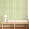 Scion Tiles Pea Green wallpaper styled behind a wooden bench, showcasing fresh green square tile design