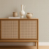Scion Tiles Mushroom wallpaper styled behind a rattan-front cabinet, showcasing soft neutral grid design.
