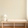 Scion Tiles Mushroom wallpaper styled behind a wooden bench, showing understated neutral grid motif design.