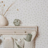 Little Dutch Blueberry Leaves White Green wallpaper styled in a nursery with wooden wall shelf and soft green accessories.