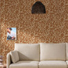 Made Varri Burnt Orange wallpaper in modern living room with flowing abstract line pattern.