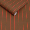 Made Kyria Caramel Red Stripe wallpaper roll close-up showing narrow red stripe pattern.