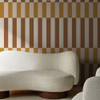 Made Terri Ochre striped wallpaper styled behind curved cream sofa.