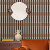 Made Sirio Caramel Blue wallpaper styled in living room with round mirror and wooden sideboard.