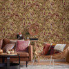 Holden Decor Lemur Leaves Berry wallpaper used on living room feature wall showing tropical jungle leaves and lemurs
