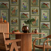 Holden Decor Tropical Frames wallpaper green feature wall with framed animal artwork behind dining table