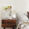 neutral floral wallpaper feature wall with bedside table, framed artwork and soft bedroom styling
