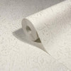 light neutral wallpaper roll with subtle floral pattern showing textured finish
