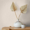 beige plaster look wallpaper feature wall with ceramic vase and dried leaf styling