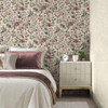 pink floral wallpaper feature wall behind bed with bedside table and soft bedroom styling