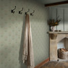 sage floral wallpaper in hallway with coat hooks, fireplace and soft traditional decor