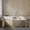 palm leaf wallpaper in bathroom with freestanding bath and neutral decor
