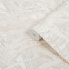wallpaper roll showing large tropical leaf design in soft neutral tones