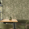 green palm leaf wallpaper in dining area with table and chairs