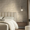 sage tropical wallpaper feature wall in bedroom with upholstered bed and pendant lighting