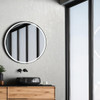 modern bathroom with grey textured wallpaper and round mirror