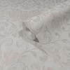 close up of wallpaper roll showing intricate damask design and subtle shimmer finish