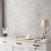 floral damask wallpaper feature wall with sideboard and decorative objects