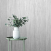 textured white wallpaper with plant and modern interior styling