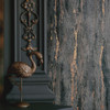 textured dark wallpaper with decorative details and moody interior setting