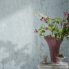 textured wallpaper in light blue tones with decorative flowers and soft lighting