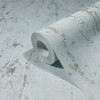 close up of wallpaper roll showing textured surface and metallic accents