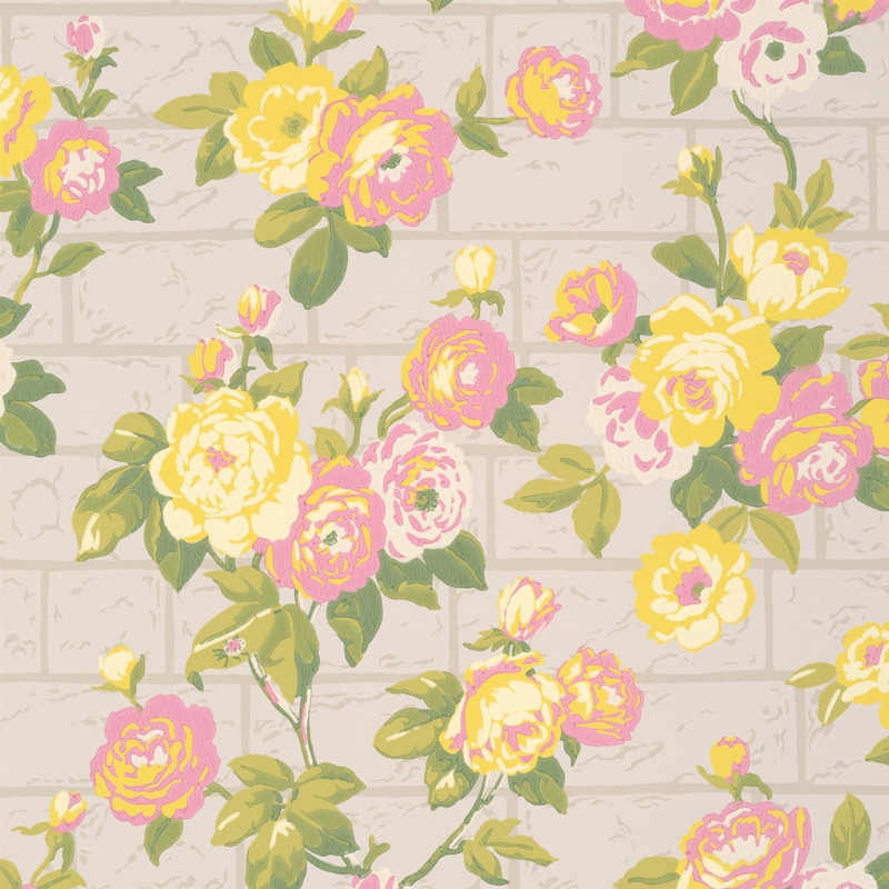 Little Greene Rose Garden wallpaper in Portland Stone, featuring yellow and blush pink roses with soft green foliage over a pale brick-effect background.