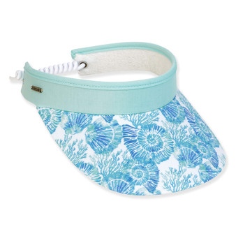 Three-quarter view of a mint green sun visor with a blue seashell print brim and white coiled elastic strap.