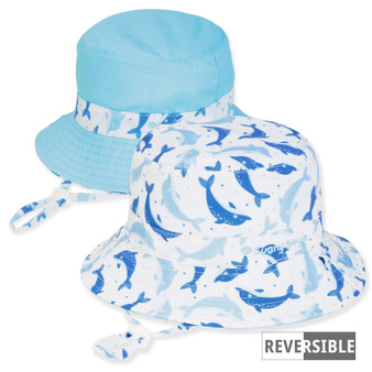 Three-quarter view of a reversible kids' bucket hat featuring a blue dolphin print side and a solid light blue side.