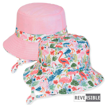 Three-quarter view of a reversible kids' bucket hat featuring a tropical flamingo print side and a solid pink side.