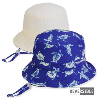 Three-quarter view of a reversible kids' bucket hat featuring a blue sea turtle print side and a solid white side.