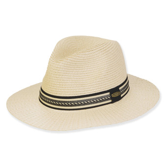 Three-quarter view of a cream straw fedora featuring a black and white geometric patterned band and oval metal logo.
