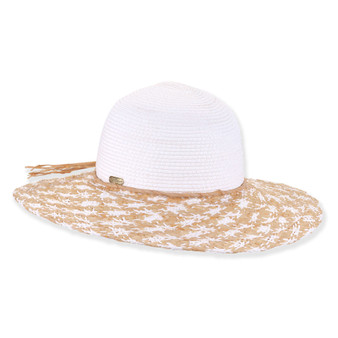 Three-quarter profile view of a white and tan woven straw floppy hat featuring a rounded crown, rope trim, and metal logo.