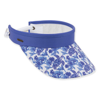 Three-quarter view of a royal blue performance visor featuring a white sea turtle print brim, white coiled elastic strap, and silver logo-plate.