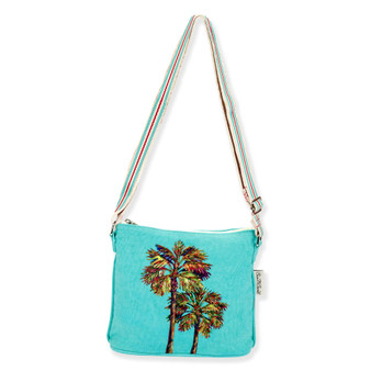 Front view of a rectangular turquoise crossbody bag featuring colorful embroidered palm trees, a striped adjustable strap, and metal hardware.