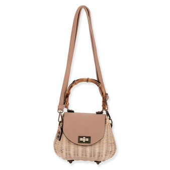 Front view of a cream wicker handbag featuring a bamboo top handle, tan leather flap, gold-tone turn-lock, and crossbody strap