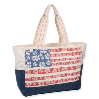 Three-quarter view of beige Guy Harvey floral flag tote featuring canvas texture, hibiscus-patterned American flag, and denim base panel.