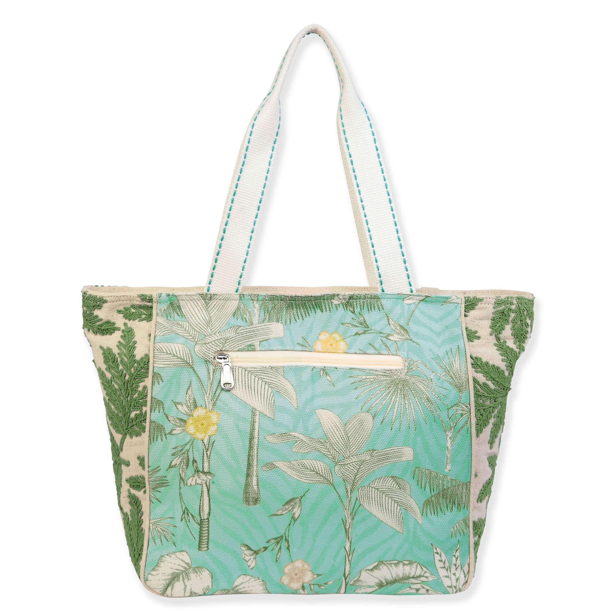 Canvas beach tote bag with leafy tropical background pattern, smooth fabric backside, rear zippered pocket detail, wide light blue handles, back view shown