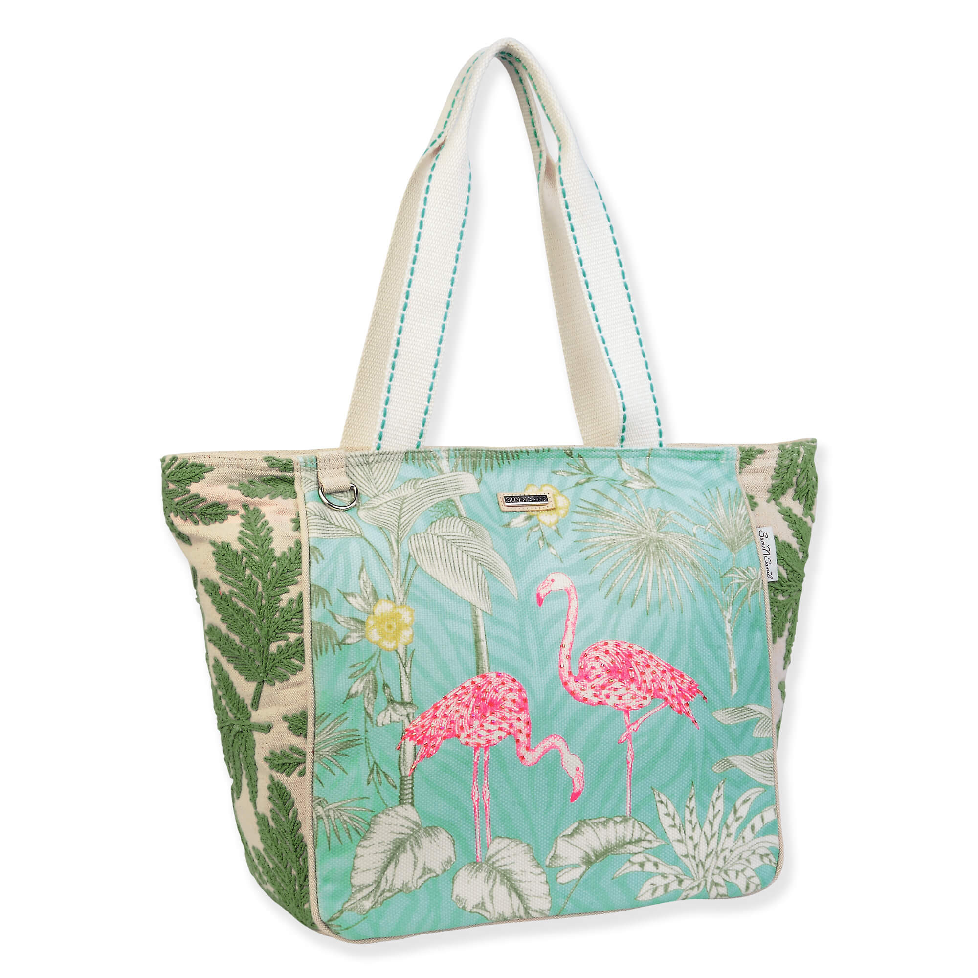 Canvas beach tote bag with illustrated pink flamingos, leafy tropical background, textured fabric panels, wide light blue handles, angled side view