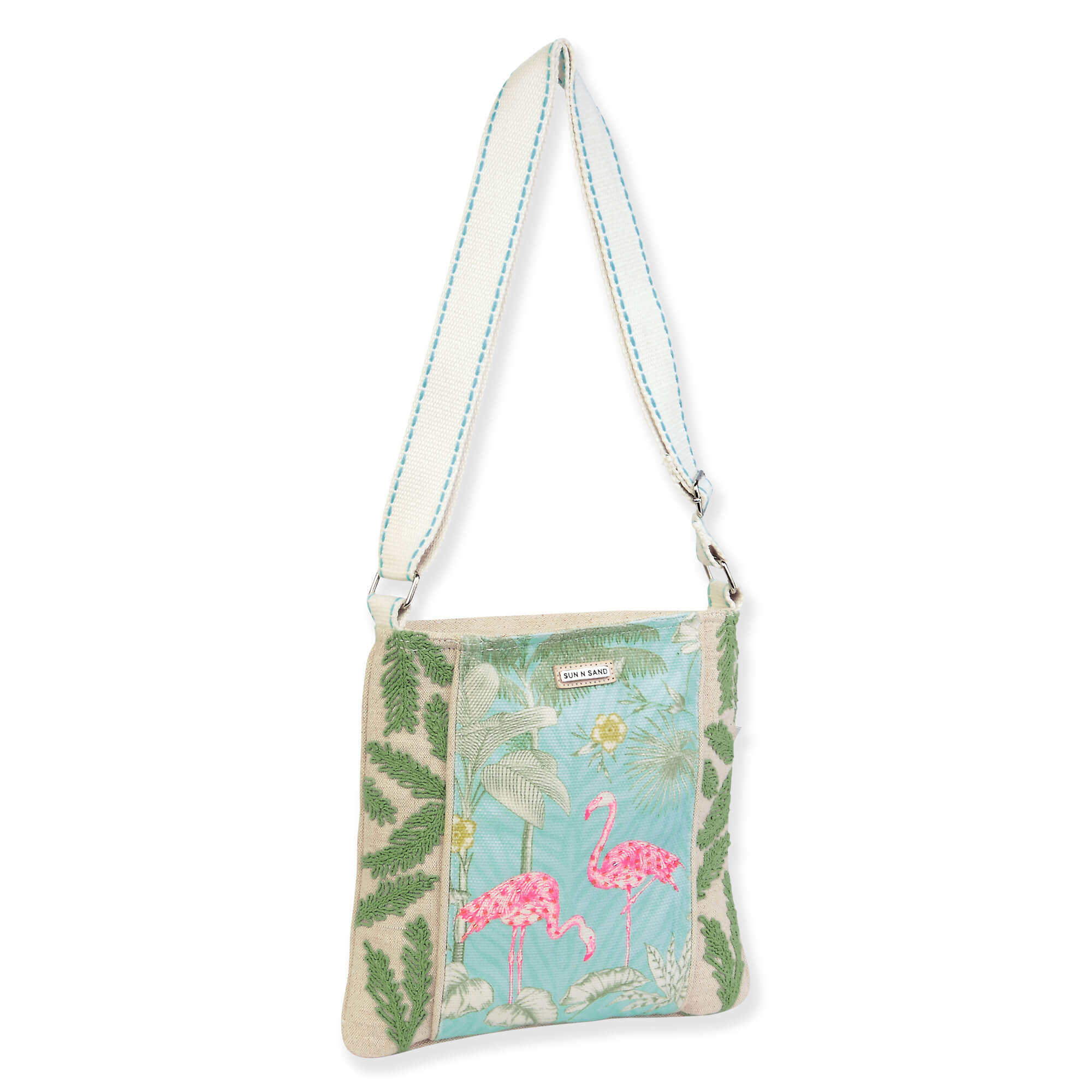 Canvas crossbody bag with tropical palm leaf print, embroidered pink flamingos, zippered pouch, adjustable light blue shoulder strap, angled side view