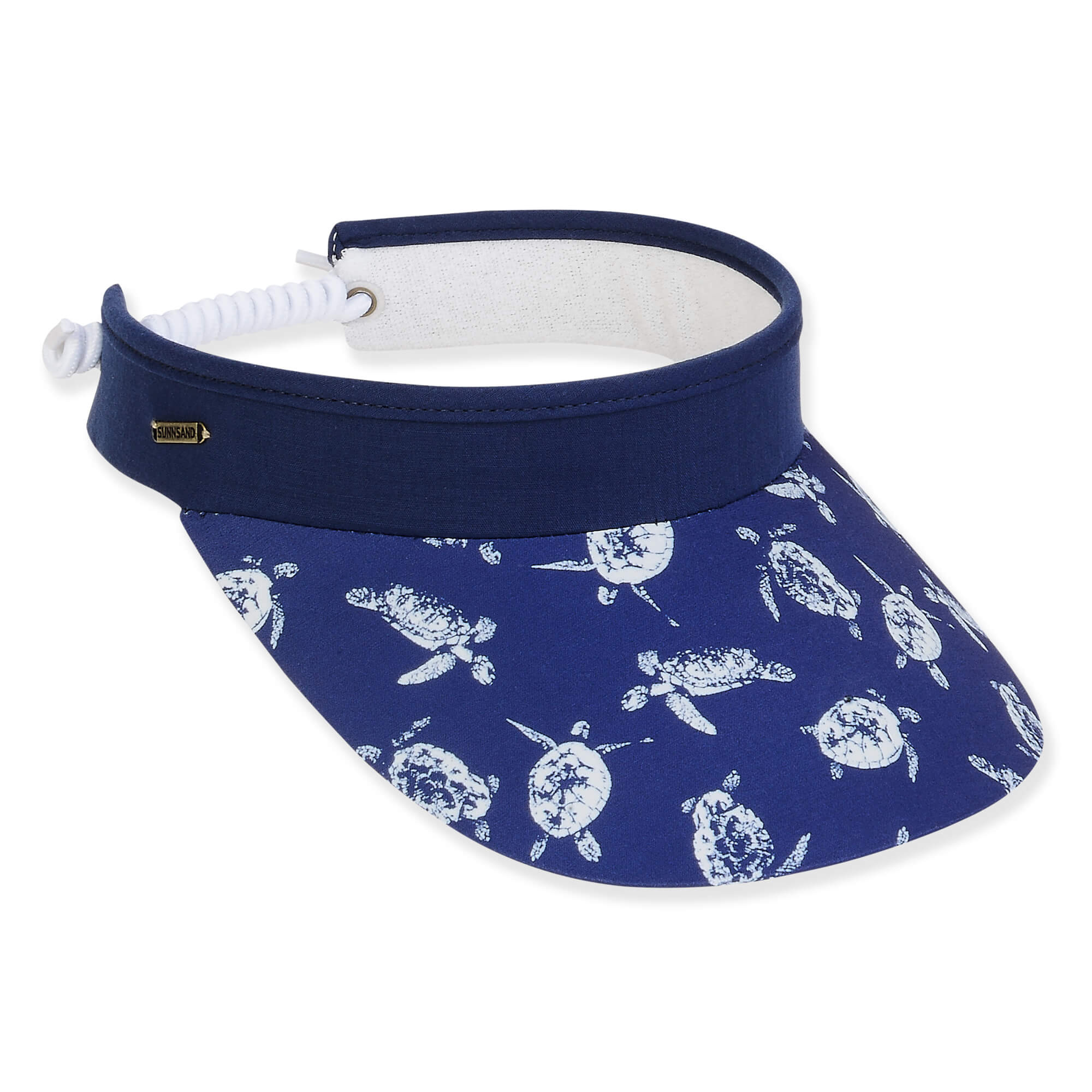 Three-quarter view of a navy blue sun visor with a white sea turtle print brim and white coiled elastic strap.