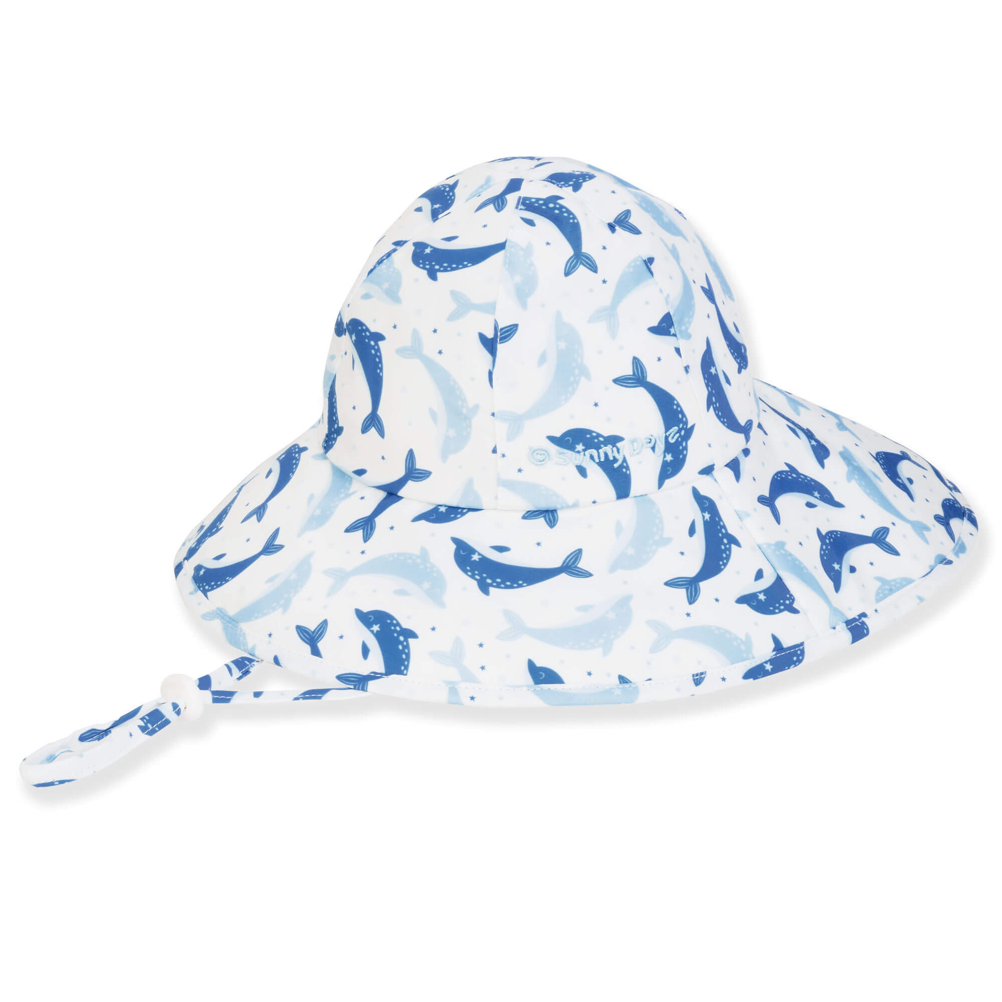 Three-quarter view of a white kids' sun hat featuring a repetitive blue dolphin print and an adjustable chin strap.