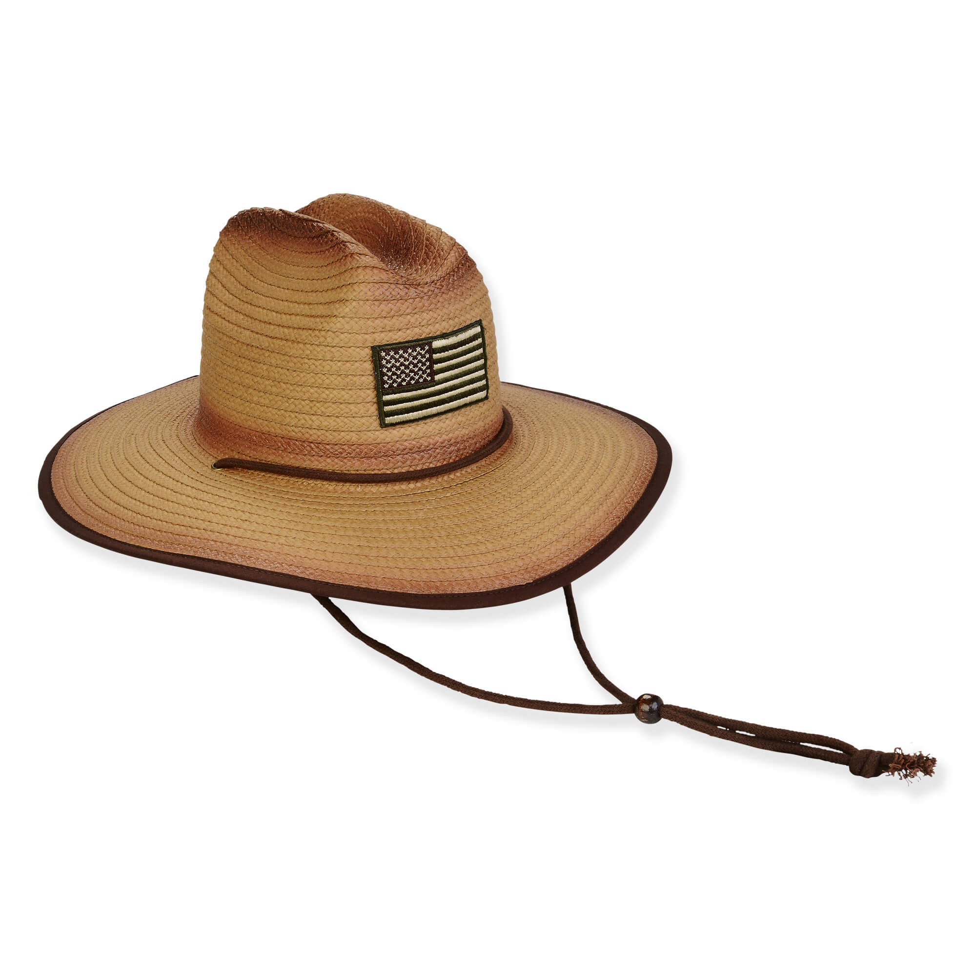 Three-quarter view of a dual-tone tan straw lifeguard hat featuring an American flag patch, brown binding, and adjustable chin cord.