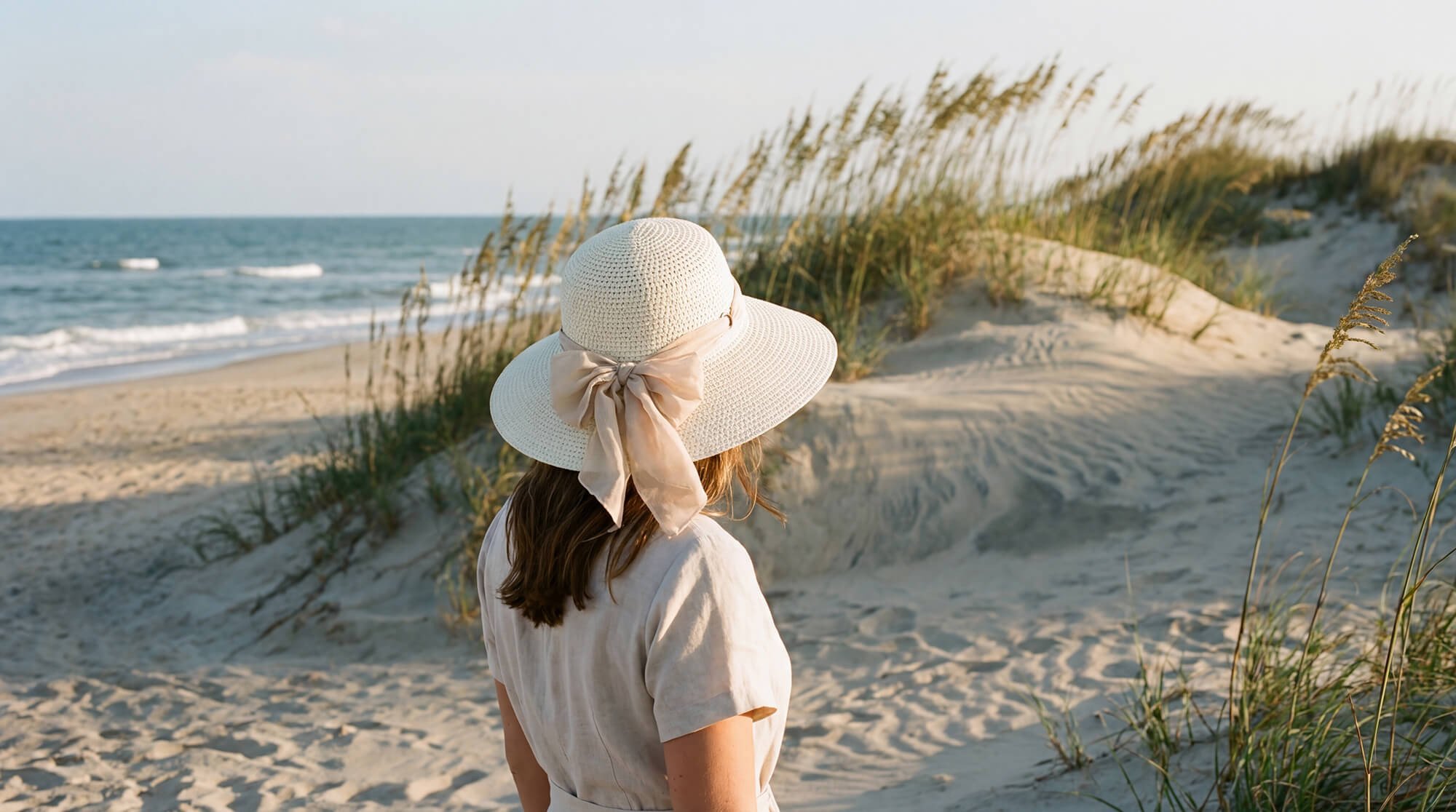 Front angled view of the Sun N Sand upturn bucket hat in natural straw, featuring curved upturned brim and adjustable UPF‑protection design.